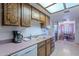 Well-maintained kitchen featuring classic cabinetry, a sink, and a view of the adjoining dining room at 520 S Greenfield Rd # 22, Mesa, AZ 85206