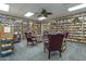 Cozy library featuring extensive bookshelves, comfortable seating, and a ceiling fan at 520 S Greenfield Rd # 22, Mesa, AZ 85206
