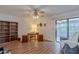 Comfortable living room with wood floors, a ceiling fan, a bookshelf, and a sliding glass door at 520 S Greenfield Rd # 22, Mesa, AZ 85206