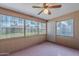 Enclosed sunroom features neutral walls and windows overlooking the yard and letting in natural light at 520 S Greenfield Rd # 22, Mesa, AZ 85206