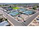 Aerial view showcasing multiple tennis courts surrounded by lush landscaping and palm trees at 520 S Greenfield Rd # 22, Mesa, AZ 85206