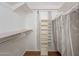 Organized walk-in closet featuring built-in shelving, a hanging rod, and ample storage space at 520 S Greenfield Rd # 22, Mesa, AZ 85206