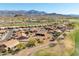 Real estate aerial view showcasing a single-story home with desert landscaping in a golf course community with mountain views at 5812 S Staghorn Cholla Ct, Gold Canyon, AZ 85118