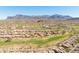 Beautiful aerial view of the community, golf course, and surrounding mountains on a clear, sunny day at 5812 S Staghorn Cholla Ct, Gold Canyon, AZ 85118
