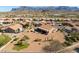 Real estate photo highlighting desert landscaping and mountain views in a residential community with well-maintained lawns at 5812 S Staghorn Cholla Ct, Gold Canyon, AZ 85118
