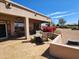 Back patio featuring a fire pit and outdoor furniture with desert landscaping and desert trees at 5812 S Staghorn Cholla Ct, Gold Canyon, AZ 85118