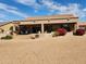Backyard view of the house featuring an outdoor grill, patio seating and desert landscaping at 5812 S Staghorn Cholla Ct, Gold Canyon, AZ 85118