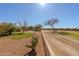 Desert landscaped property featuring a walking path and native trees at 5812 S Staghorn Cholla Ct, Gold Canyon, AZ 85118