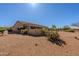 Backyard featuring desert landscaping, a covered patio, and stucco privacy walls at 5812 S Staghorn Cholla Ct, Gold Canyon, AZ 85118