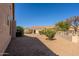 Backyard with gravel landscaping, mature bushes, and a view of the rear of the home at 5812 S Staghorn Cholla Ct, Gold Canyon, AZ 85118