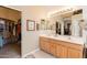 Bathroom with a double vanity, framed mirrors and ample counter space and walk-in closet at 5812 S Staghorn Cholla Ct, Gold Canyon, AZ 85118