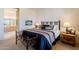 Comfortable bedroom with soft, neutral tones and a wrought iron bench at the foot of the bed at 5812 S Staghorn Cholla Ct, Gold Canyon, AZ 85118