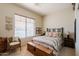 Bedroom boasts a window, comfortable seating, a chest, and a queen bed at 5812 S Staghorn Cholla Ct, Gold Canyon, AZ 85118