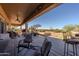 Spacious covered patio with a ceiling fan, desert landscaping, outdoor seating, and a bar area, perfect for enjoying the outdoors at 5812 S Staghorn Cholla Ct, Gold Canyon, AZ 85118