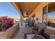 Spacious covered patio featuring ample seating, ceiling fan, and desert landscaping, perfect for relaxation and entertaining in style at 5812 S Staghorn Cholla Ct, Gold Canyon, AZ 85118