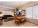 Open-concept dining area with wood table, fireplace, and adjacent living space at 5812 S Staghorn Cholla Ct, Gold Canyon, AZ 85118