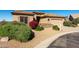 Inviting home exterior with desert landscaping, a stone accented facade, and spacious driveway at 5812 S Staghorn Cholla Ct, Gold Canyon, AZ 85118