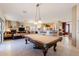 Open floor plan showcasing a billiard table, access to the kitchen, living room and views of the outdoor patio at 5812 S Staghorn Cholla Ct, Gold Canyon, AZ 85118