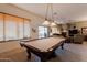 Entertaining game room with a pool table, a window seat, and natural light streaming through blinds at 5812 S Staghorn Cholla Ct, Gold Canyon, AZ 85118