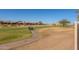 Scenic golf course view featuring a winding path, lush greenery, and well-maintained landscaping at 5812 S Staghorn Cholla Ct, Gold Canyon, AZ 85118