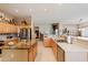 Bright kitchen featuring an island with granite countertop, maple cabinets, and stainless appliances at 5812 S Staghorn Cholla Ct, Gold Canyon, AZ 85118