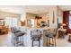 Open kitchen with a large breakfast bar, tile flooring, light wood cabinets, and stainless-steel appliances at 5812 S Staghorn Cholla Ct, Gold Canyon, AZ 85118