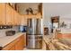 Kitchen featuring stainless steel refrigerator and maple cabinets at 5812 S Staghorn Cholla Ct, Gold Canyon, AZ 85118