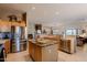 Open kitchen boasts stainless steel appliances, an island, and maple cabinets at 5812 S Staghorn Cholla Ct, Gold Canyon, AZ 85118