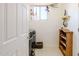 Tiled laundry room with a window, shelving, and modern washer and dryer at 5812 S Staghorn Cholla Ct, Gold Canyon, AZ 85118