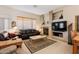 Cozy living room featuring a fireplace, tv, and comfortable seating at 5812 S Staghorn Cholla Ct, Gold Canyon, AZ 85118