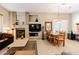 Cozy living room with a fireplace, comfortable seating, and an adjacent dining area for easy entertaining at 5812 S Staghorn Cholla Ct, Gold Canyon, AZ 85118