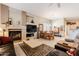 Open living room with a fireplace, tv, and adjacent dining area at 5812 S Staghorn Cholla Ct, Gold Canyon, AZ 85118