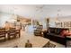 Open-concept living room featuring tile floors, a ceiling fan, and seamlessly connects to the dining area and kitchen at 5812 S Staghorn Cholla Ct, Gold Canyon, AZ 85118
