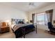 Comfortable main bedroom showcasing a king bed, soft lighting, and a glimpse of the outdoor scenery at 5812 S Staghorn Cholla Ct, Gold Canyon, AZ 85118