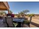 Cozy patio area with a mosaic tile table and desert landscaping at 5812 S Staghorn Cholla Ct, Gold Canyon, AZ 85118