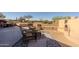 Outdoor patio featuring a fireplace, comfortable seating, desert landscaping, creating a perfect space for outdoor relaxation and entertaining at 5812 S Staghorn Cholla Ct, Gold Canyon, AZ 85118