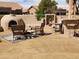 Backyard patio featuring an outdoor kitchen, patio seating and desert landscape at 5812 S Staghorn Cholla Ct, Gold Canyon, AZ 85118
