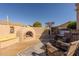 Outdoor patio featuring a fireplace, comfortable seating, and stylish decor, creating a perfect space for outdoor relaxation and entertaining at 5812 S Staghorn Cholla Ct, Gold Canyon, AZ 85118