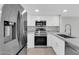 Updated kitchen featuring stainless steel appliances, white cabinetry, and granite countertops at 604 E Weber Dr # 12, Tempe, AZ 85288