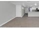 Open-concept living room with tile floors leading into the kitchen with white cabinets at 604 E Weber Dr # 12, Tempe, AZ 85288