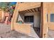 Exterior view of the patio area with a metal security gate and decorative potted plants at 604 E Weber Dr # 12, Tempe, AZ 85288