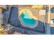 Aerial view of a kidney bean-shaped community pool with clean turquoise water and secure fencing at 604 E Weber Dr # 12, Tempe, AZ 85288