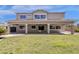 View of the spacious backyard, manicured lawn, and covered patio at 6204 S Banning St, Gilbert, AZ 85298