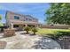 Exterior view of the two-story home showcasing the spacious backyard, stone barbecue and covered patio at 6204 S Banning St, Gilbert, AZ 85298