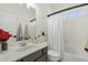 Bright bathroom with modern vanity, mirror, toilet, shower-tub combo and vanity at 6204 S Banning St, Gilbert, AZ 85298