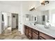 Bathroom with dual sinks, spacious counter, tile floors, and separate water closet at 6204 S Banning St, Gilbert, AZ 85298