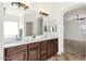 Bathroom with dual sinks, spacious counter, and decorative lighting at 6204 S Banning St, Gilbert, AZ 85298