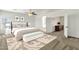 Cozy bedroom with neutral decor, carpet, bench, and an open doorway to the en-suite bathroom at 6204 S Banning St, Gilbert, AZ 85298