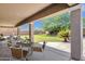 Inviting covered patio with outdoor seating overlooking a lush green lawn and mature landscaping at 6204 S Banning St, Gilbert, AZ 85298