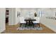 Bright dining room with modern table, white chairs, patterned rug, and shuttered windows at 6204 S Banning St, Gilbert, AZ 85298